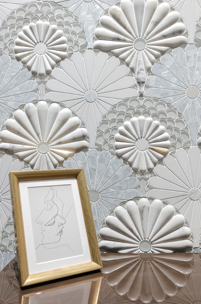 Fantasy Fan waterjet mosaic in Calacatta Gold, Thassos, White Rivershell, and White Glass featuring sculpted fan-shaped patterns on a decorative interior wall.